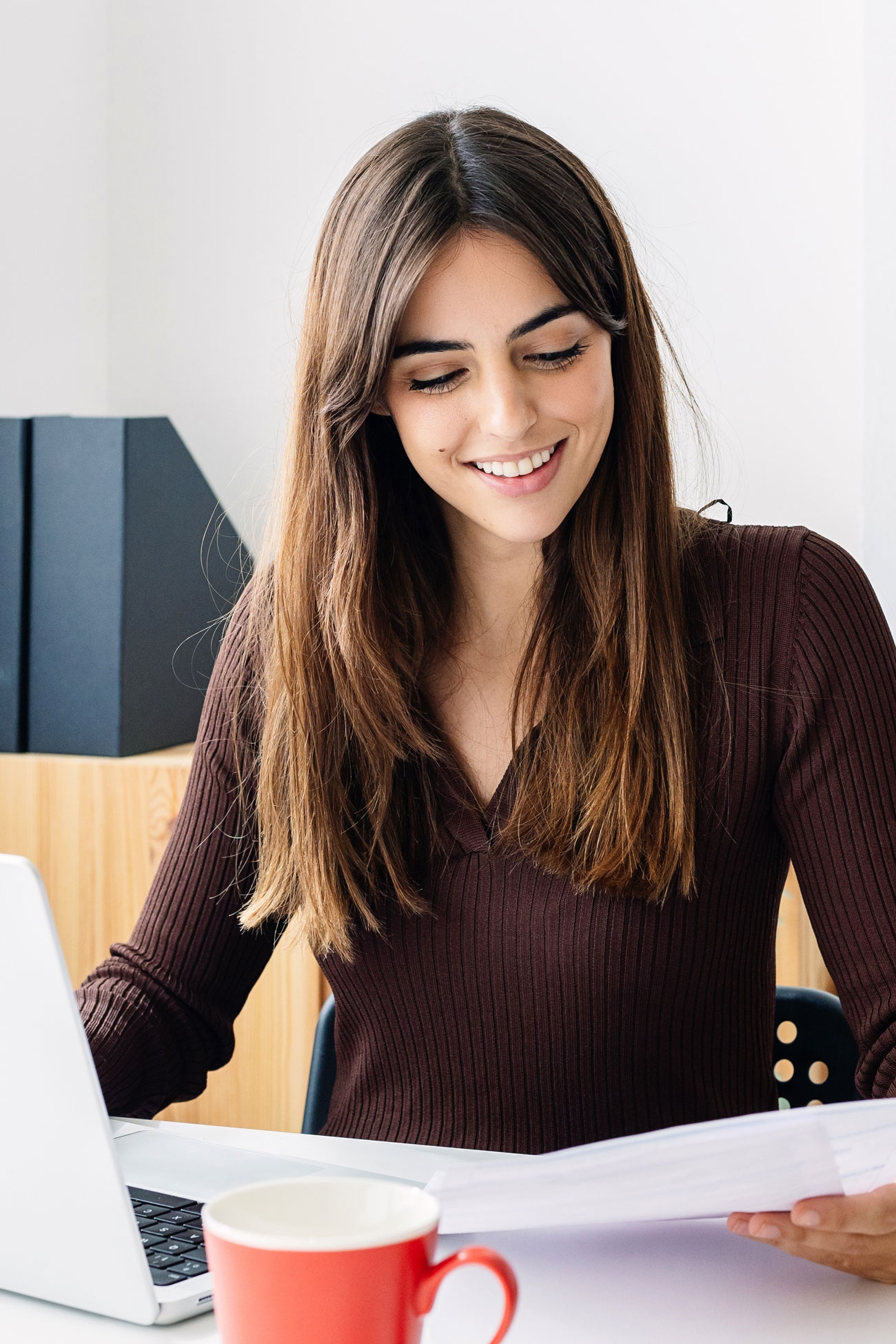 Woman Smiling Reading Phone Bills