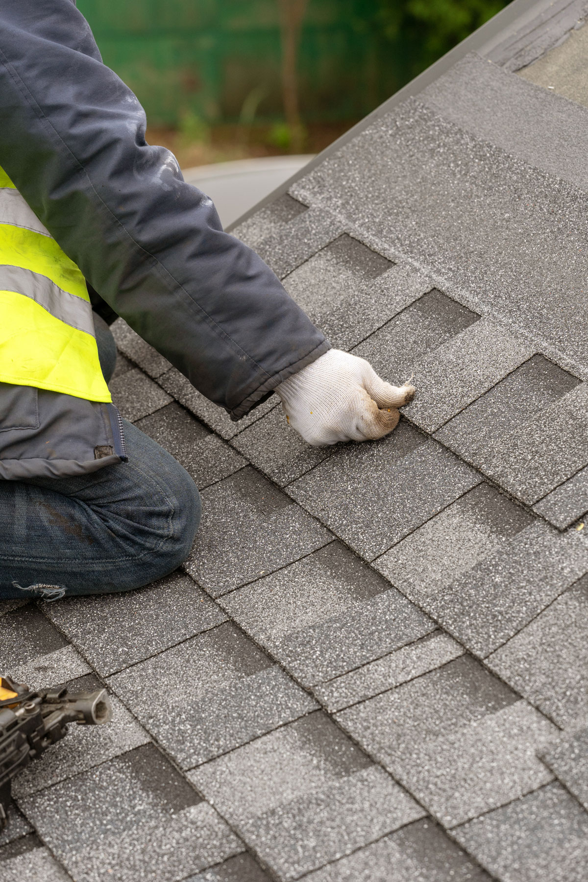 Expert Roofer Fixing Gray Shingles
