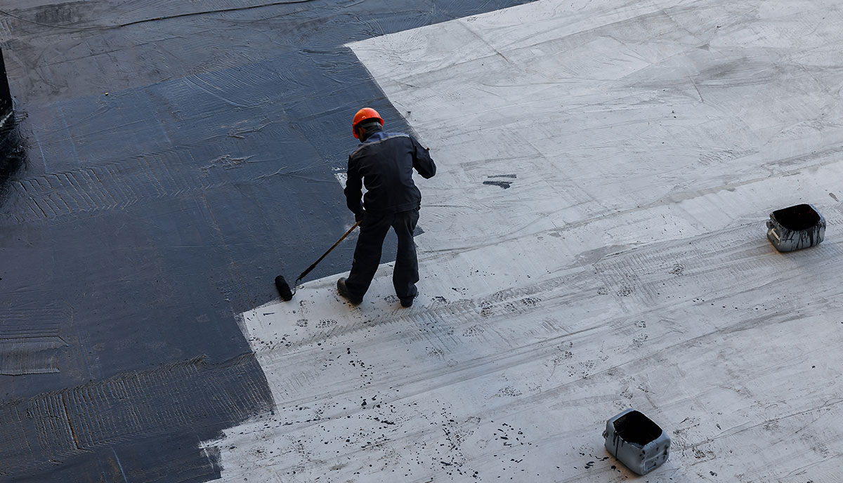 Expert Roofer Painting Flat Roof