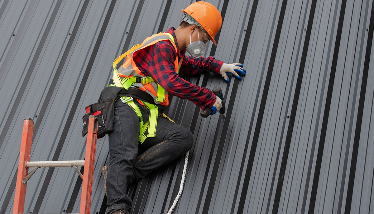Expert Roofer Constructing Metal Roof in Houston